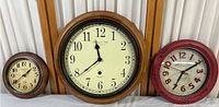 Three wall clocks of different sizes, showing overall look and condition