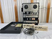 Overview of recorder, lid, microphone boxes, cables, reel and manual