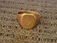 Close-up of the 10k gold Masonic ring showing the Masonic emblem and engraving details on the band.