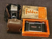 Two vintage cameras: Argus Seventy-Five with leather case and Foldex 20 in box