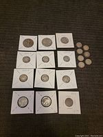 Overall view of coin lot showing multiple collectible coins including silver Walking Liberty half dollars, Mercury dimes, Roosevelt dimes, and smaller modern coins, some encased in protective holders with dated notes.
