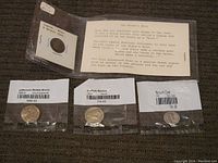 Photo showing three American coins in individual plastic bags with labels: Jefferson Nickel Bison, Buffalo Nickel, and Mercury Dime, along with a typed card describing the biblical significance of the Widow's Mite (Lepton).