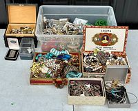 Overview of multiple storage boxes and containers filled with assorted jewelry pieces