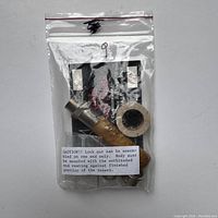 Fly fishing rod reel seat packed in a plastic bag with assembly instructions.