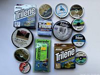 Photo showing multiple fishing lines and accessories from above on a white background.