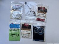 Fly fishing leaders in packaging and a metal snap swivel wire for fishing.