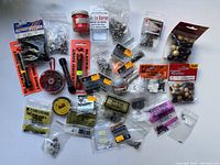 Photo showing entire lot of various fishing weights and accessories arranged on table.