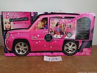 Front and side view of new Barbie Fashionistas pink car in box.