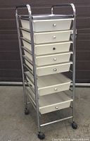 Front view showing all seven drawers in the chrome frame with wheels