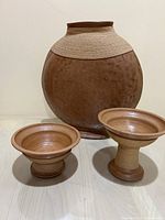 Photo showing entire set with large ceramic vase and two smaller resin pedestal bowls in earthtone colors.