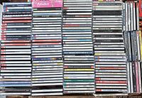 Large number of classical music CDs stacked side by side showing spines with titles and artists, including sets of double CDs and multiple releases.