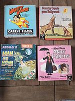 Four vintage 8mm movie film sleeves: Mighty Mouse, Country Coyote goes Hollywood, Apollo 11 Man on Moon, Mary Poppins