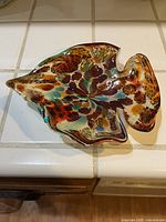 Top view of fish-shaped Murano glass dish with mottled tutti frutti colors showing detailed color variations and shape.