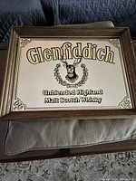 Full view of the vintage Glenfiddich bar mirror with wooden frame, showing branding and stag logo.