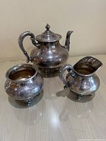 Full view of the Reed & Barton vintage silverplate tea set showing teapot, creamer, and sugar bowl together.