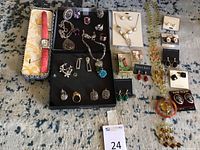 Overall lot shot showing all jewelry pieces and watch