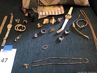 Overall view of all jewelry pieces on dark fabric surface