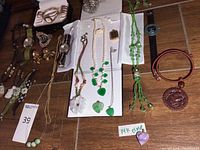 Full overview of watches, bracelets, necklaces and jewelry laid out on wood surface