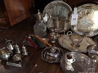 Overall lot view of silver plated trays, sterling pieces, decanter and goblets