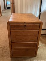 Front view of the wooden 2-drawer file cabinet with visible lock on the top drawer.