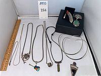 Overview of all 11 jewelry pieces: chains, cord necklace, chokers, brooches and pendants