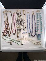 All necklaces laid out on white display pad