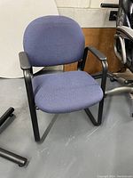 Single dark blue waiting room style chair with black metal sled base and plastic armrests.