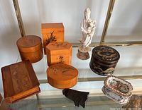 Photo showing the full lot including trinket box, four wooden boxes, Chinese porcelain dish, black bell-shaped ink, and figurine.