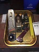 Collection of four various Stanley hand planes and one black small plane in a metal tray