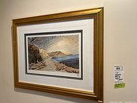 Overall wall view of framed Emily Carr Shoreline print hung next to MaxSold lot sticker