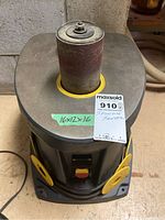 Top-down view of Mastercraft spindle sander with sanding drum mounted and green tape label showing dimensions 16x12x16.