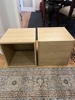 Two wooden boxes, light wood finish, one upright and one on side showing hollow interior.