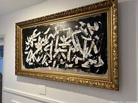 Frontal view of entire framed painting mounted on wall