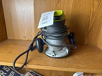 Front view of Ryobi wood router showing overall condition, color and coiled power cord