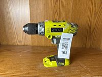 Right side profile showing Ryobi branding, venting, and grip handle details.