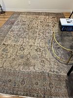 Full view of rug on hardwood floor with coffee table on top