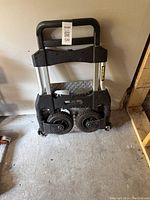 Side view of the dolly in folded position showing compactness and stair-climbing wheels.