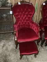 Overview of red velvet tufted parlour chair paired with matching footstool