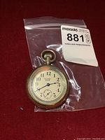 Front view of pocket watch showing dial with 'Winner CWC' marking, Arabic numerals, and seconds subdial.