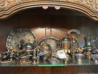 Wide shot of shelf with all silverplate pieces