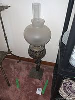 Full view of the lamp showing base, font, frosted shade and chimney