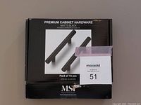 Box showing packaging with label “Premium Cabinet Hardware Matte Black” and brand MSA, showing product image of two black handles on the front.