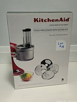 Sealed original box showing KitchenAid branding and images of the food processor with dicing kit attachment and discs.