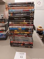 Stack of various DVDs showing different movie and TV series titles in good condition