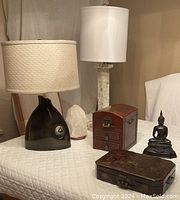Group view of two table lamps, salt lamp, two jewellery boxes and Buddha statue