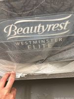Close-up photo showing the Beautyrest Westminster Elite label on the mattress covered in plastic.