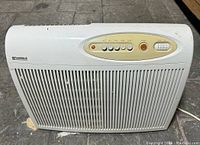 Full frontal view showing the white Kenmore air purifier with front grill and top control panel.