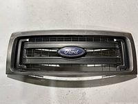 Full frontal view of the Ford truck grill showing the entire grille and emblem for clear identification.