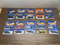 Photo showing all 10 cars new on original cards arranged on a table with various colors and some card wear