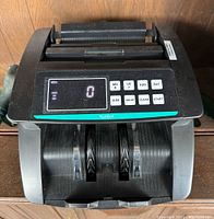 Front view of the black Kolibri bill counter showing digital display with count zero and control buttons.